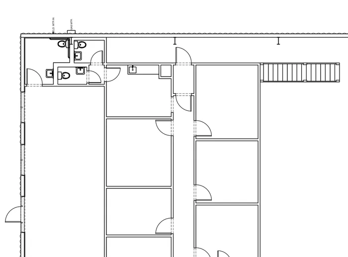 Close-up of the sample floor plan: offices, restrooms, doors and fixtures.